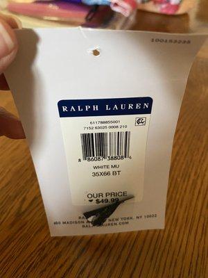 The tag with the original price underneath the altered sticker price of $70