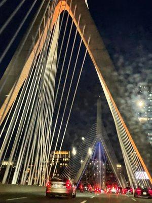 The Zakim Bridge looks like the strings of a Giant Harp. The futuristic multi lane Boston bridge connects commuters to many popular places