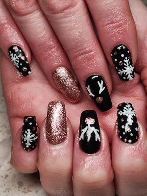 Winter nails on acrylic. All art is freehand. Black and rise gold with white details.