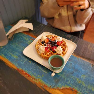 Belgian waffle with cinnamon whipped cream and berries