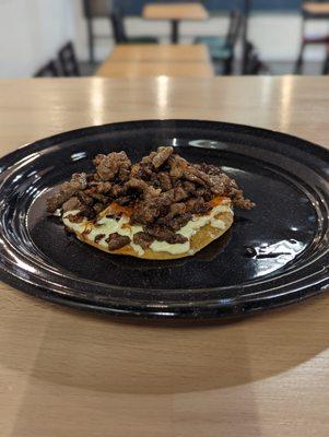 Steak Volcan!  Tostada with melted cheese and your choice of meat!