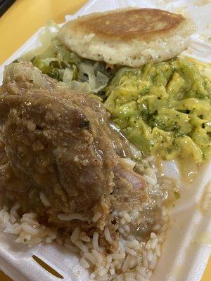 Smothered pork chops on white rice with broccoli and cheese and cabbage - fried cornbread