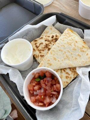 Chicken quesadilla to go. Included salsa and sour cream on side.