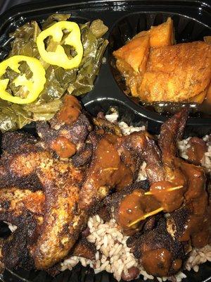 Jerk chicken plate w/ sides and sauce on