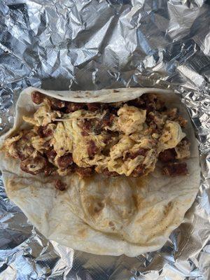 Chorizo and egg taco on flour tortilla.