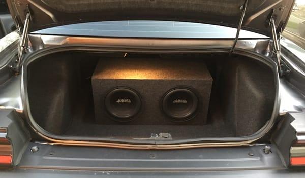 Two 10" subwoofers installed with the box amps and cabling.