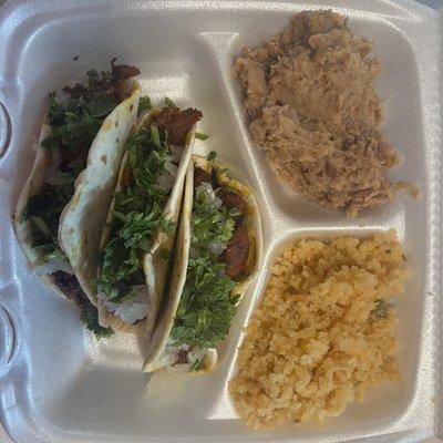 Delicious taco plate 3 tacos and a side of rice and beans