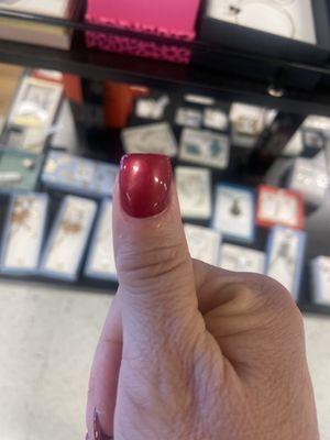 The obvious screwed up nail she didn't file evenly.