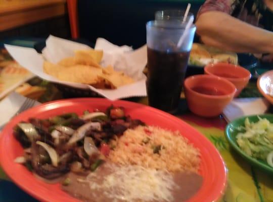 Beef fajitas with refried beans,rice,peppers and onions served with pico di gallo sour cream and tortillas