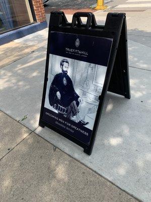 Sandwich board on front pavement