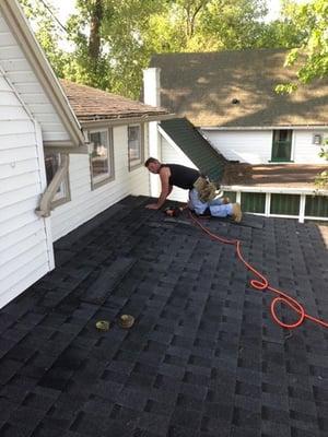 Laying down a new roof for a customer on Conesus Lake.