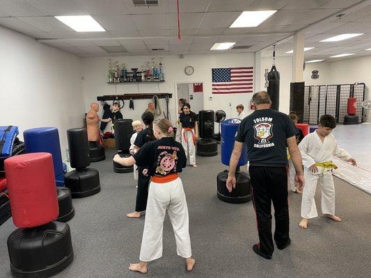 Sifu Alan Myrtle has the Kenpo kids warming up on the bags.