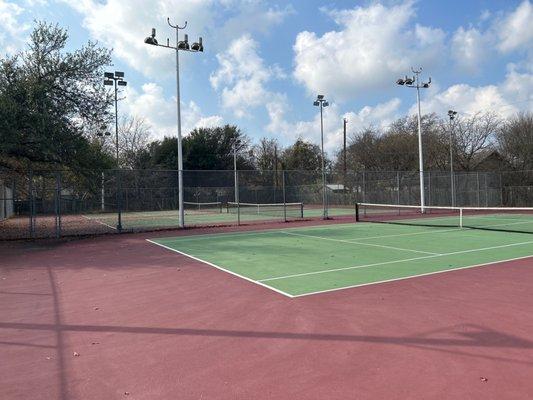 Three tennis courts with lighting