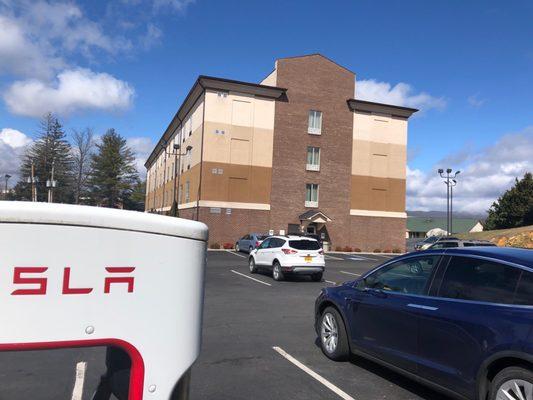 Chargers on left side of Holiday Inn as viewed from the front entrance.  Enter lot on right side of building.