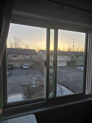 Double slider bedroom window with white frame and black hardware.