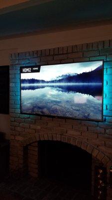 4K TV mount on fireplace. Also lighting and all components behind tv.