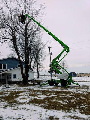 Trimming broken branches from an ice storm.