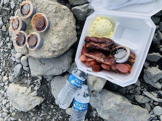 3 meat platter. Ribs, sausage, and brisket. The rolls and potato salad was what we chose for sides and both were great!