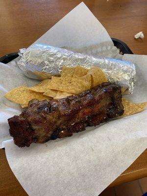 Rib meat burrito with an extra rib on the side