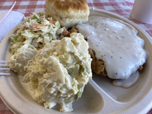 Fried steak, potato salad, biscuit, coleslaw