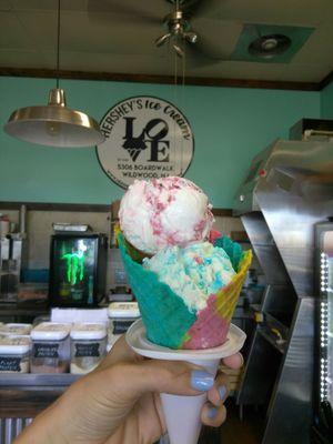 Tye dye waffle cone with.. Bottom scoop: birthday cake.. Top scoop : raspberry runner