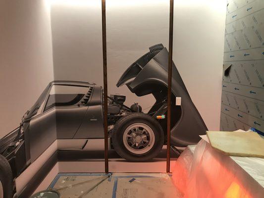 Wallpapered doors with Lamborghini mura mural.