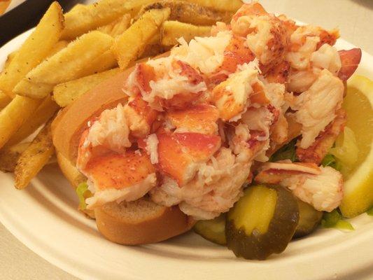 THIS is a lobster roll! Over a quarter pound of lobster meat overflows the bun!