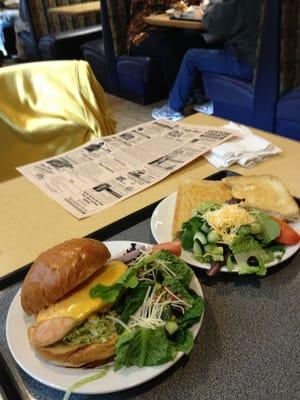 Chicken and grilled cheese sandwich with a side salad.