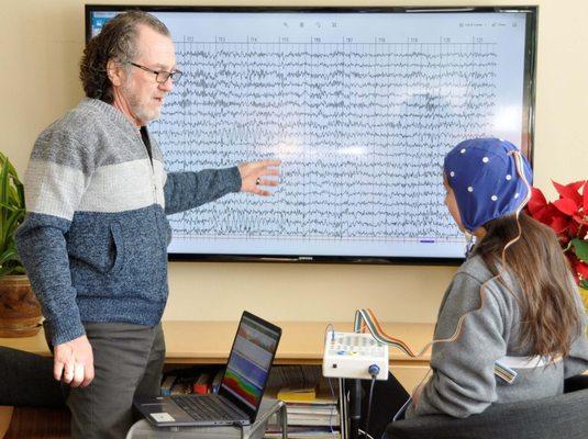 Reviewing Quantitative EEG information with mock patient. We use qEEG to guide Neurofeedback therapy.