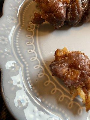 Apple fritter with hair in it