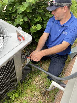 Our Tech doing an inspection on an HVAC unit, making sure its ready for the next season