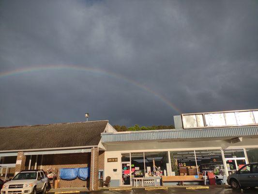 Store frontage of Tammy's Tiny Tots clothing and accessories. Notice the big beautiful rainbow up above.