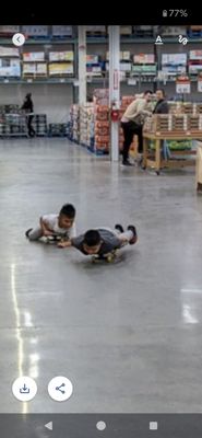 Body surfing on skateboards: Parents: do YOUR job and keep kids safe. Store staff: don't turn your backs and pretend you don't see it.