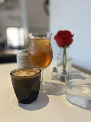 A bevy of beverages. In front, a cortado, and behind a specialty tea.