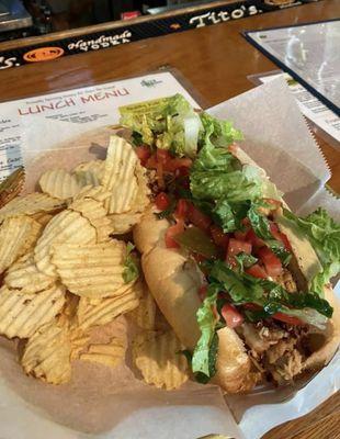 Turkey cheesesteak with chips.