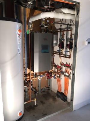 In floor heat w/ 96% eff boiler, w/ 80 gal hot water storage tank.