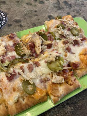 Buffalo chicken flatbread with added pickled jalapeños!