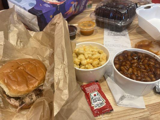 Pork sandwich, macaroni and cheese, and baked beans.