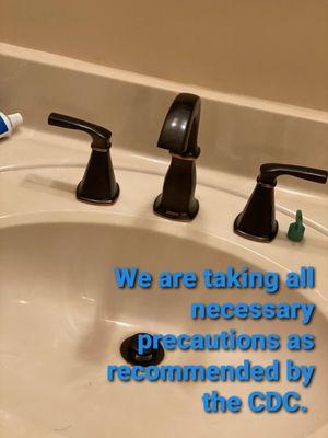 Updated bathroom faucet with text about how our company Bert Norman's Plumbing follows the CDC guidelines in Lakewood, FL.