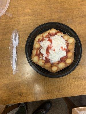 Bubble waffle w/starwberries and whipped cream.