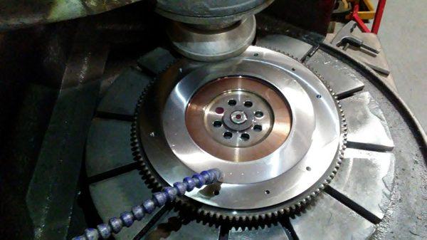 Grinding a stepped flywheel