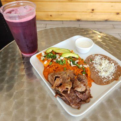 Red chilaquiles with carne asada and beans