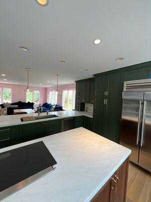 Custom green kitchen cabinets and Dunn Edwards "Strawberry Blonde" (DE 5107) in the living room