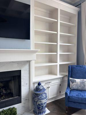 Built-in shelves and fireplace mantle.