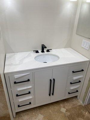 Custom vanity installation with faucet and clicker drain.