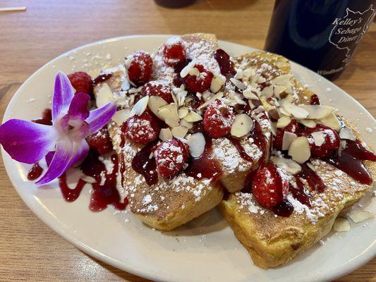 Raspberry almond French toast.  Rich in egg .. no skimping on the soaking