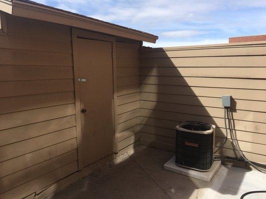 Front patio has a storage shed