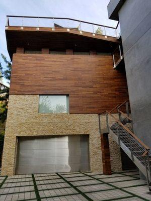 Exterior siding and driveway stone install in Beverly Hills home.