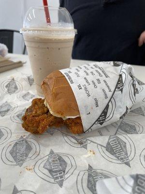 Spicy chicken sandwich with a chocolate shake.