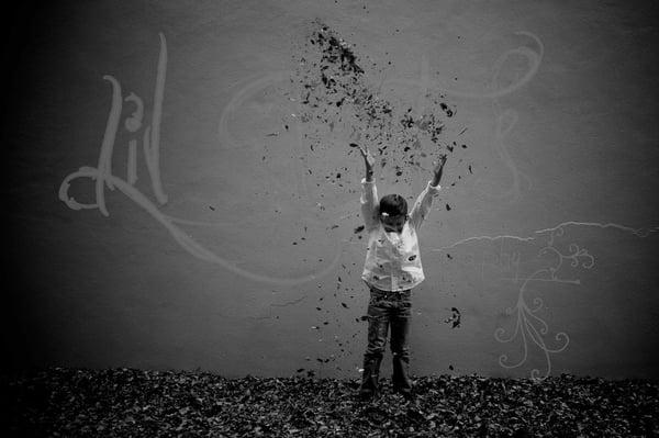 Little boy playing in the fall leaves...contemporary shot...